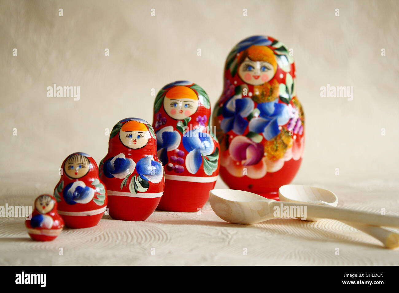 Row Russian Matryoshkas and two wooden spoons Stock Photo
