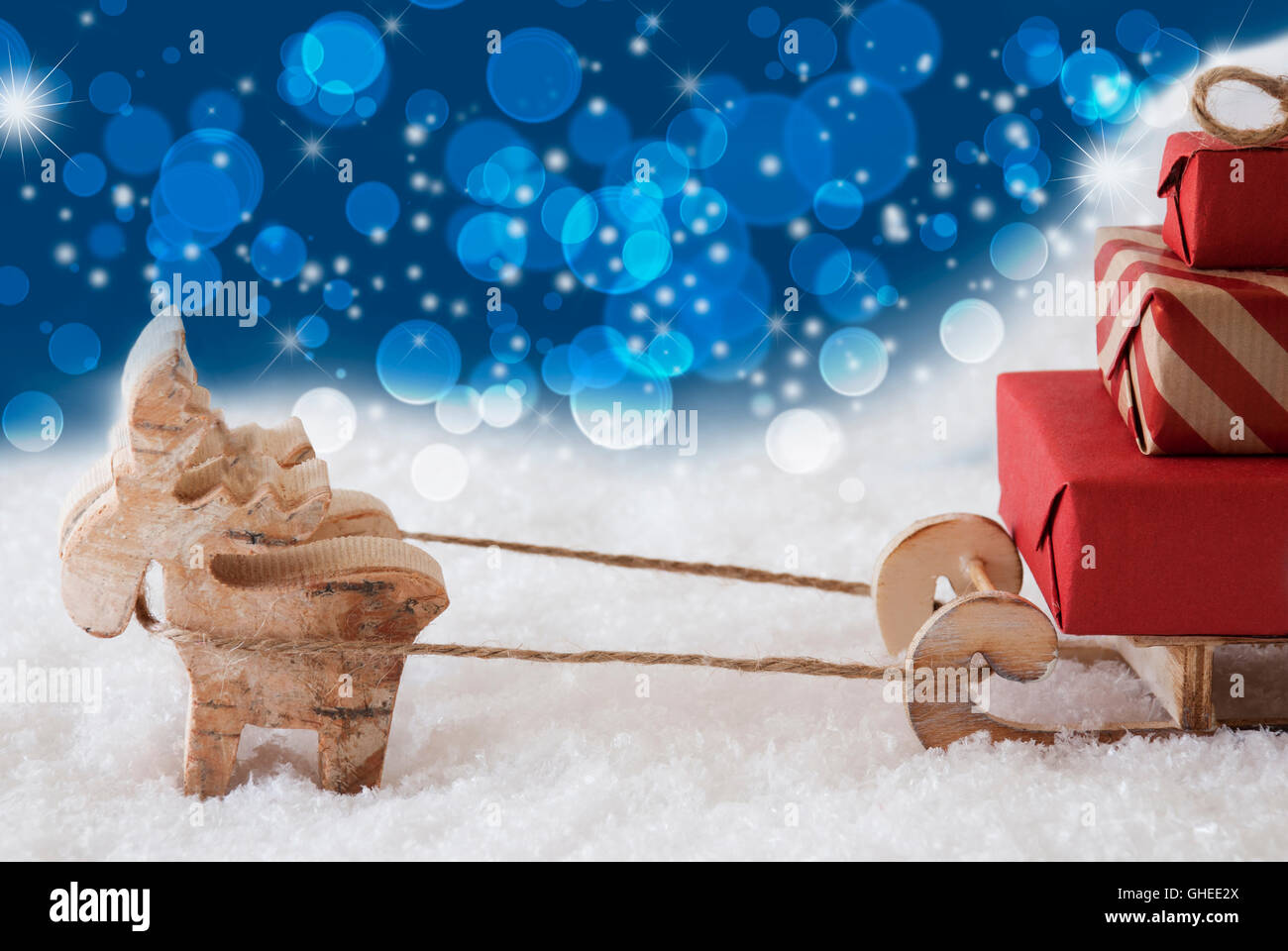 Reindeer With Sled, Blue Bokeh And Stars Background, Copy Space Stock