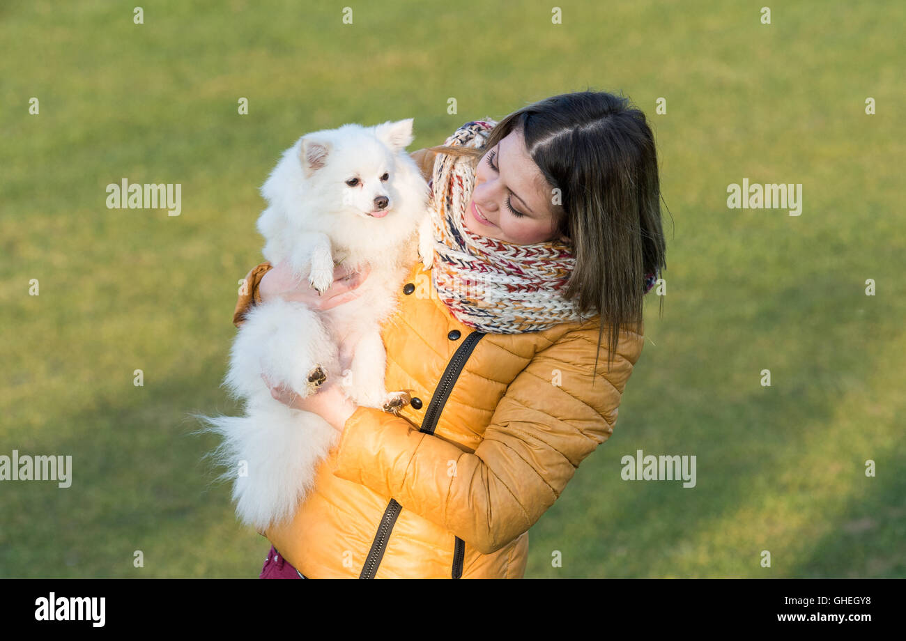 Happy girl with her little dog in nature Stock Photo - Alamy