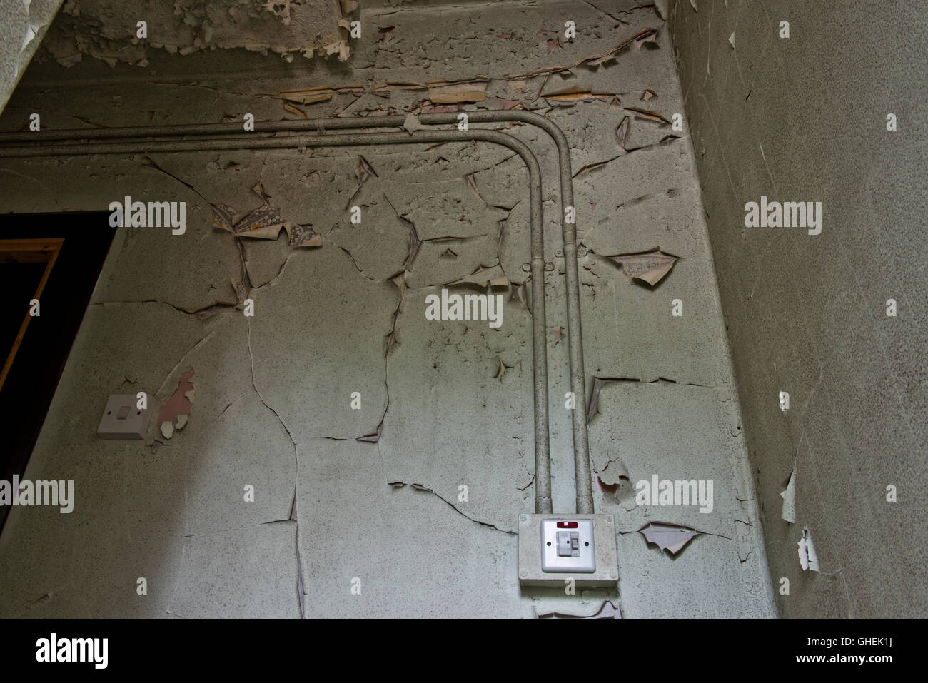 Flaky paint on the walls inside De Salis Hall Within the closed