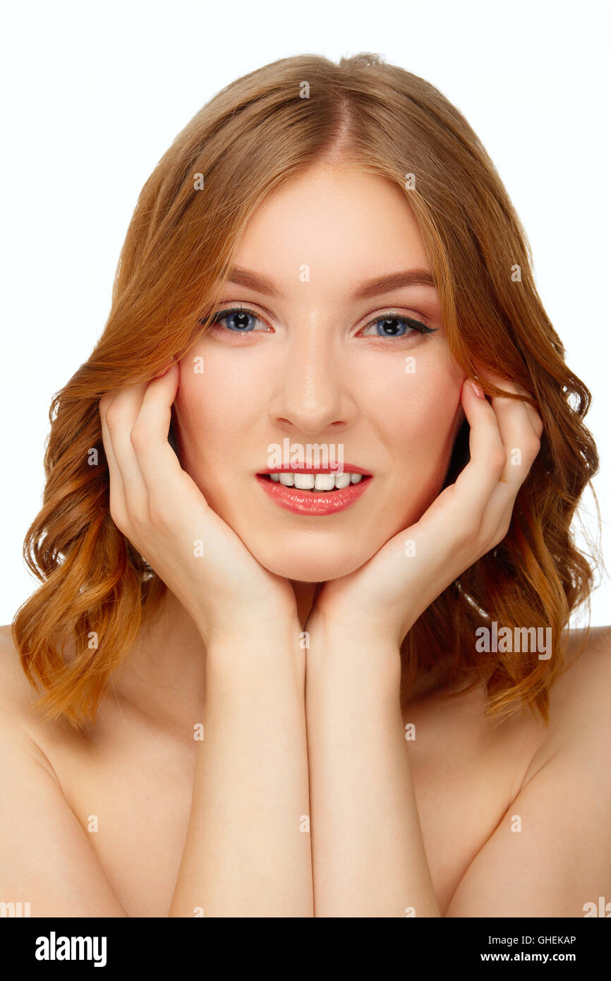 Beautiful young woman with blue eyes and red lips touching her chin ...