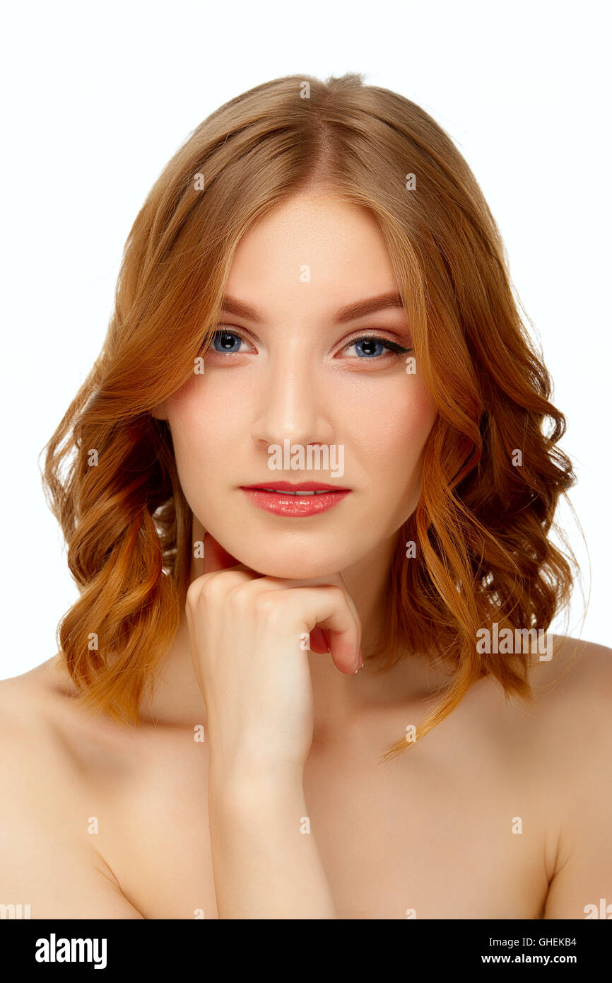 Portrait of beautiful young woman with blue eyes and red lips touching ...