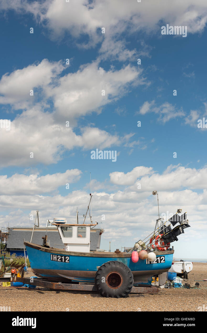 Commercial fishing boats, nets and equipment on the shingle beach at
