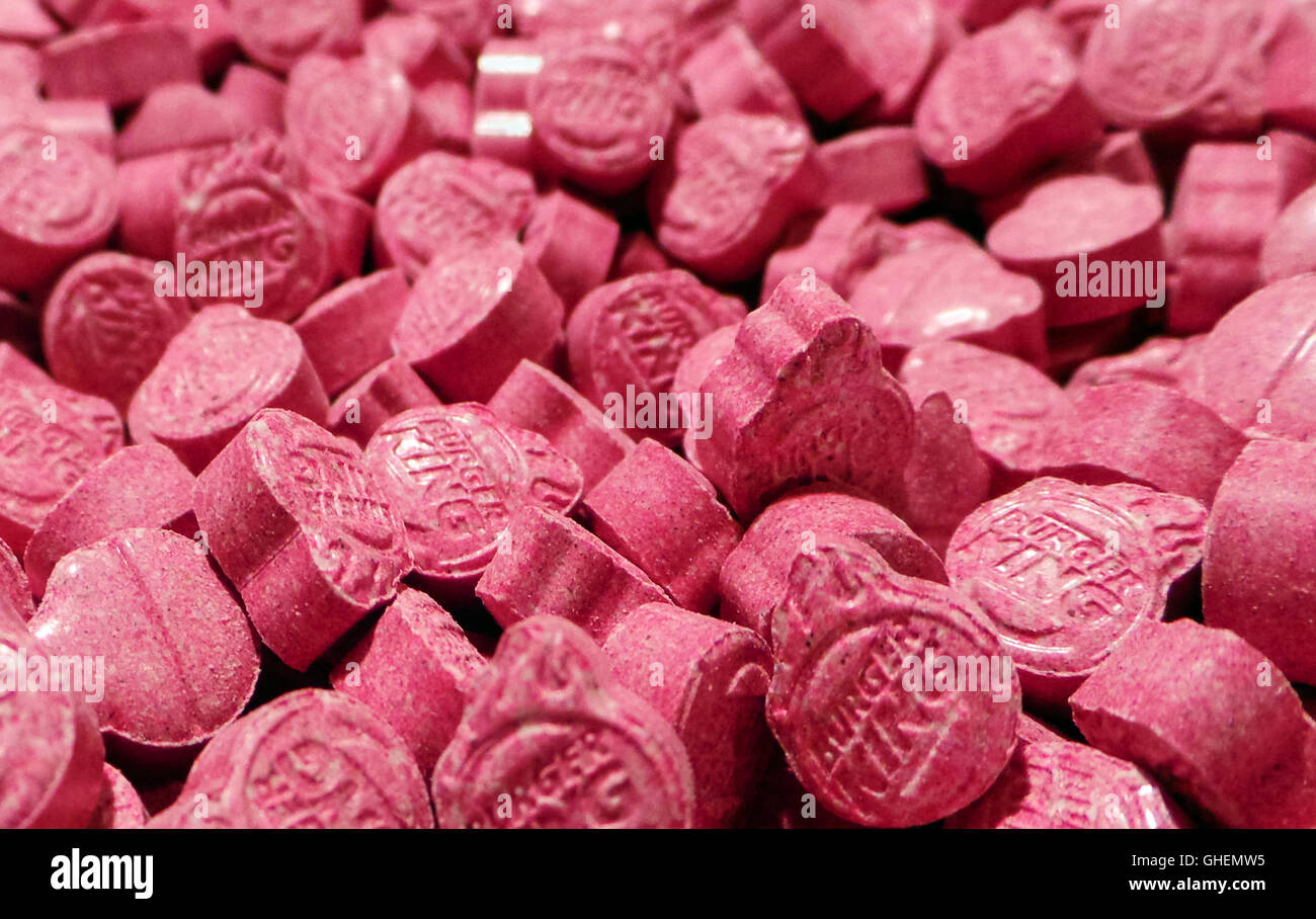 Newly pressed “Pink Burger King” Ecstasy pills containing between 250-300mg of MDMA (3,4-methylenedioxy-N-methylamphetamine). Dutch pills introduced circa October 2014, some of the largest (over 6mm thick) and strongest pills ever produced. Stock Photo