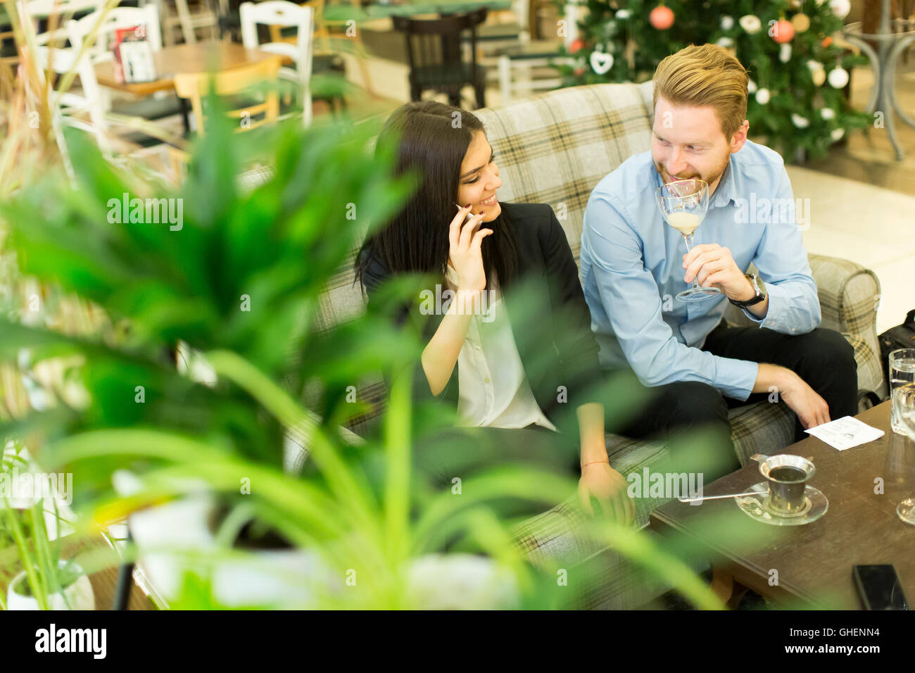 Young business people sitting in a cafe during a break Stock Photo Alamy