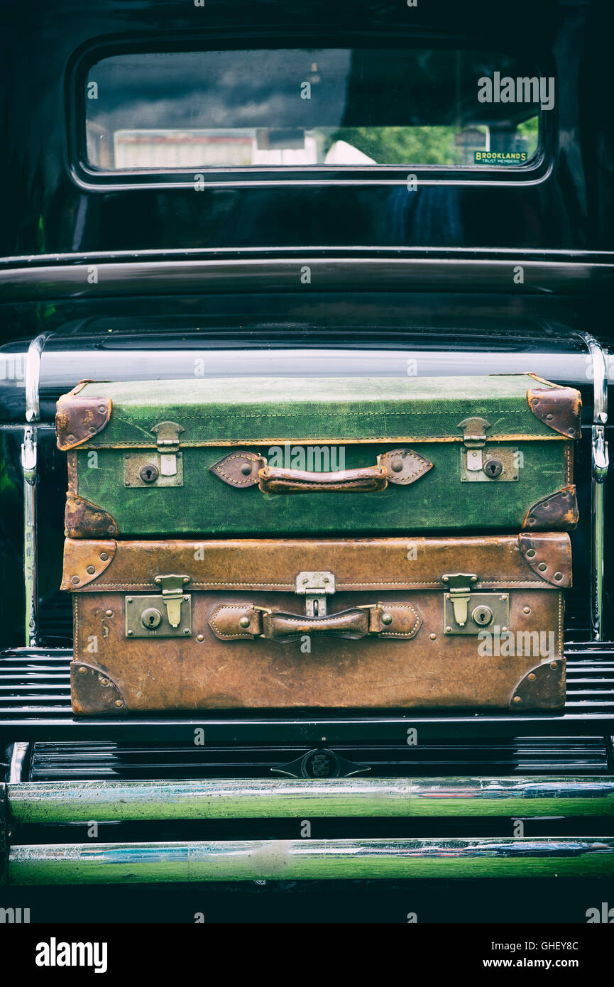 Old traveling suitcases on a 1930 Cadillac. UK. Vintage filter applied Stock Photo