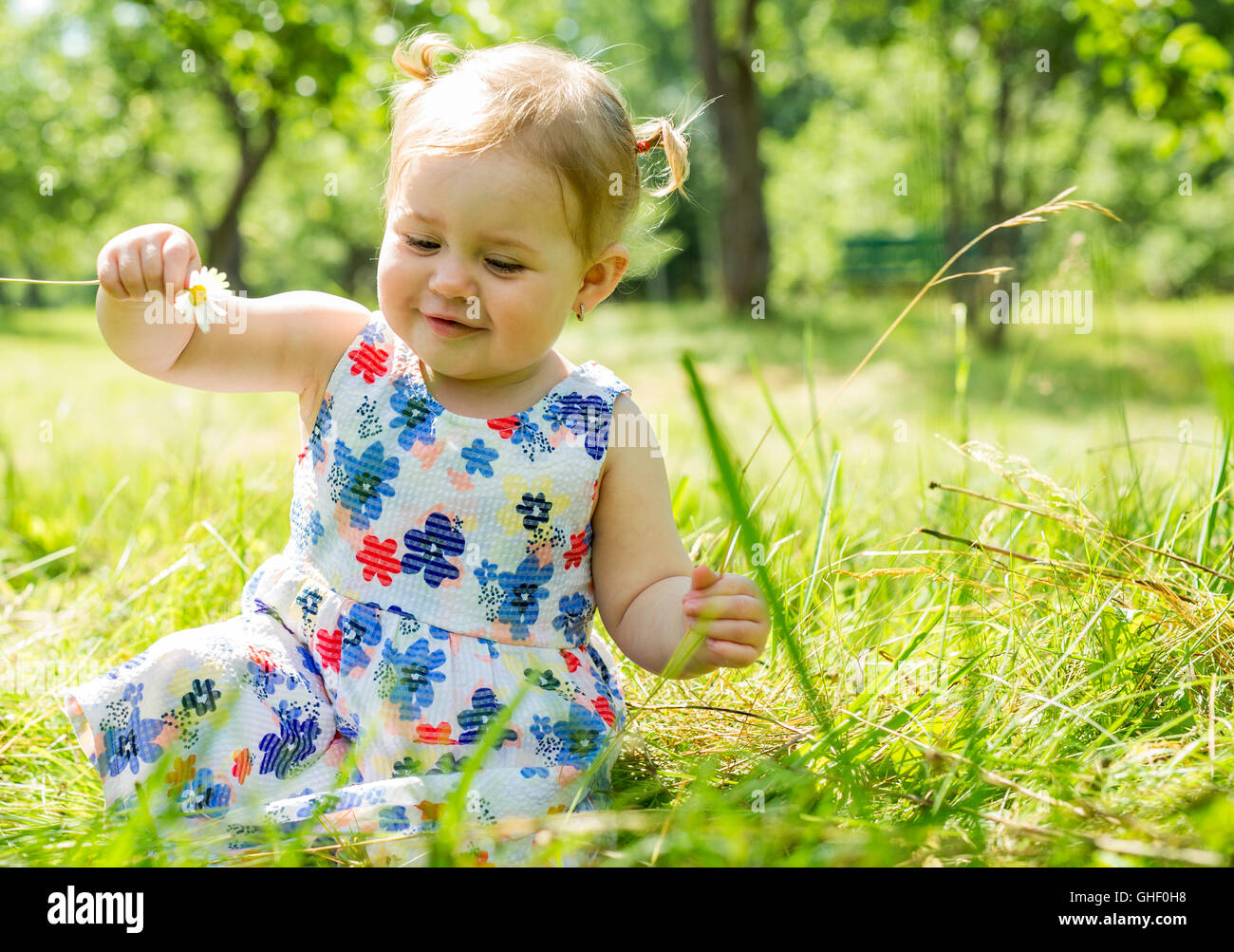 Little girl in the forest park Stock Photo - Alamy