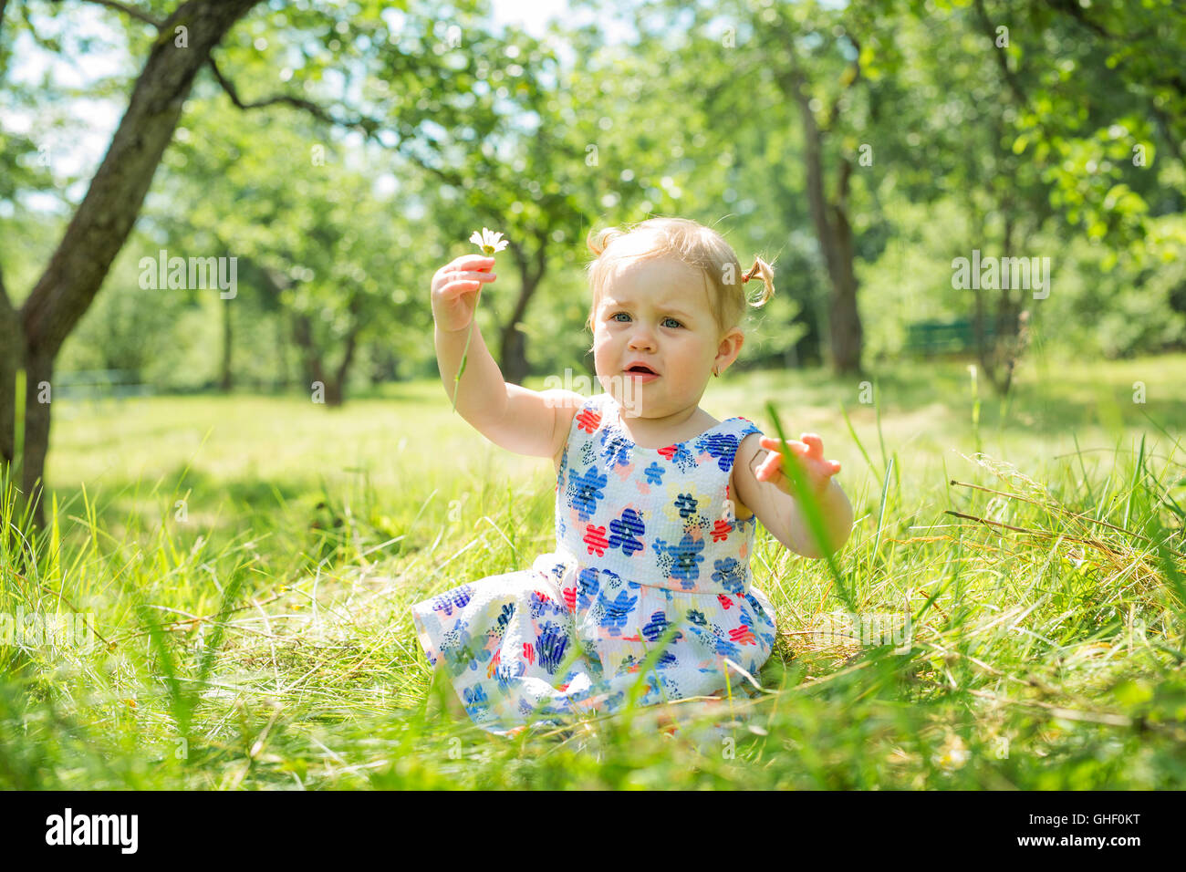 Little girl in the forest park Stock Photo - Alamy