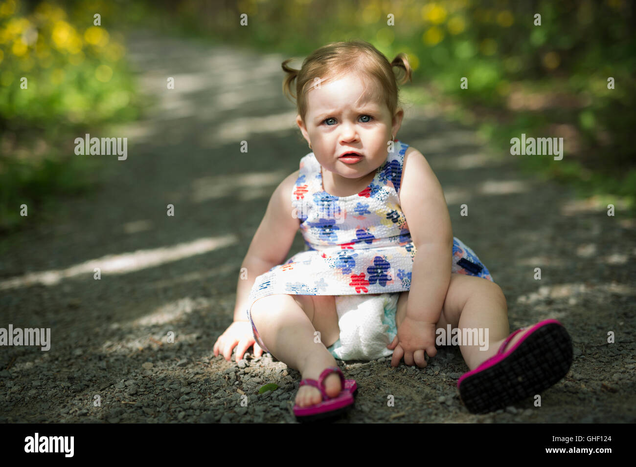 Little girl in the forest park Stock Photo - Alamy