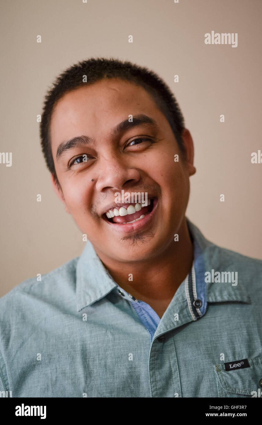 grin young man teeth pearly whites smile laugh laughter smiles portrait tightshot man boy lad Stock Photo
