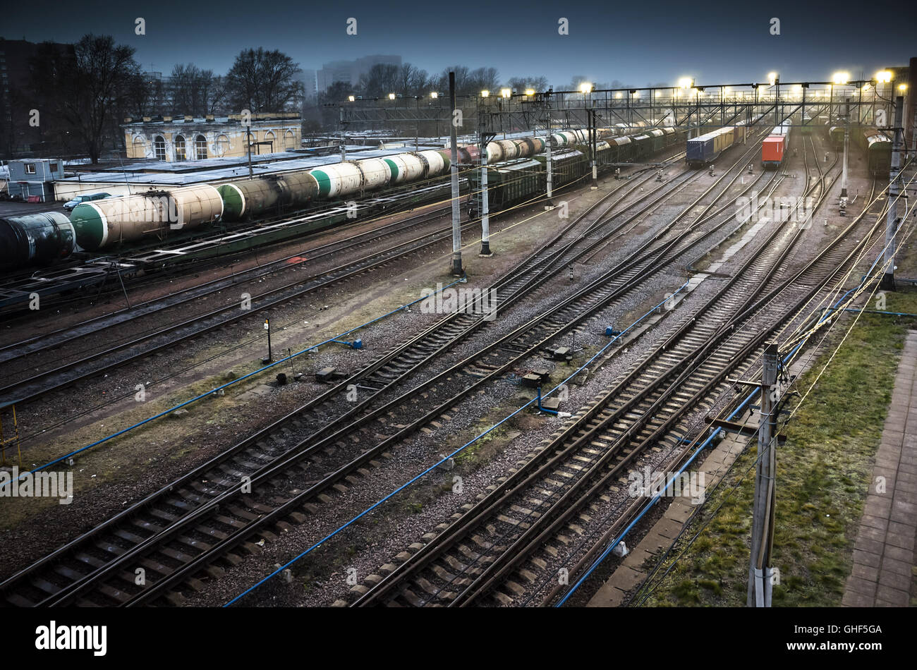 Sorting railway station with cargo trains on rails at night Stock Photo