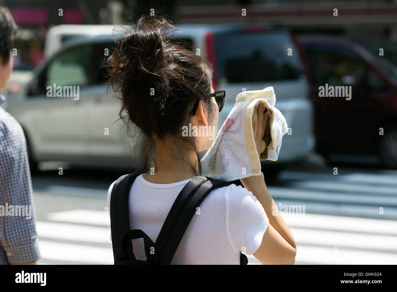 A woman wipes her sweat on a hot day in downtown Tokyo on August 5, 2016, Tokyo, Japan. The Japan Meteorological Agency registered temperatures of 35C degrees in Tokyo, making this one of the hottest days of the year. The current heatwave is expected to bring hot days next week across country. The government issued heat stroke warnings because of the high temperatures. © Rodrigo Reyes Marin/AFLO/Alamy Live News Stock Photo