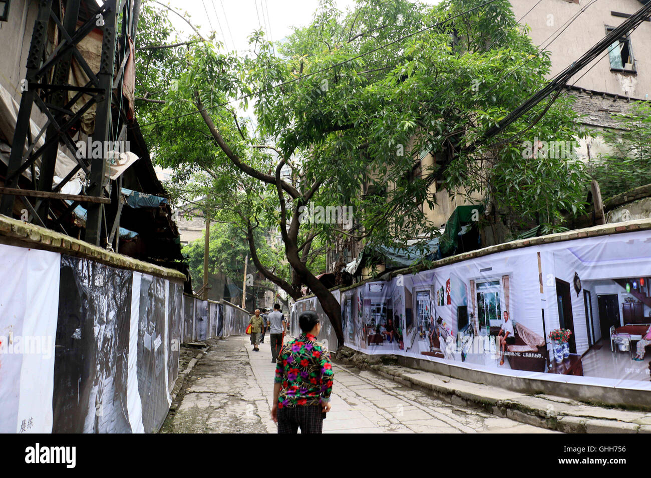 Chongqing, Chongqing, China. 27th Sep, 2016. Chongqing, CHINA-September 27 2016:?(EDITORIAL?USE?ONLY.?CHINA?OUT) More than 500 portraits of local residents of Eighteen Staircases Area are showed on the walls at the construction site in Yuzhong District, southwest ChinaÂ¡Â¯s Chongqing, September 27th, 2016. The Eighteen Staircases Area, an old area reflecting typical life of Chongqing People, started to be demolished and reconstructed in July, 2010, and now the reconstruction will be completed soon. The exhibition showcases the authentic Chongqing life of residents in the Eighteen Staircas Stock Photo