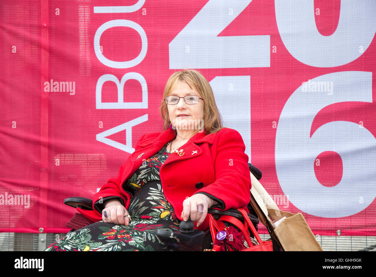 Liverpool, UK. 28th September, 2016.  Disabled Jacqueline Robinson cuts a lonley figure outside the entrance to the Labour Party conference in Liverpool.  Jacqueline, a paid up member of the Labour Party has been suspended & banned from attending the conference.  She is a member of the Unite & Communications Workers Union and an activist for DPAC, 'Disabled People Against Cuts' and a lifelong Labour supporter. Credit:  Cernan Elias/Alamy Live News Stock Photo