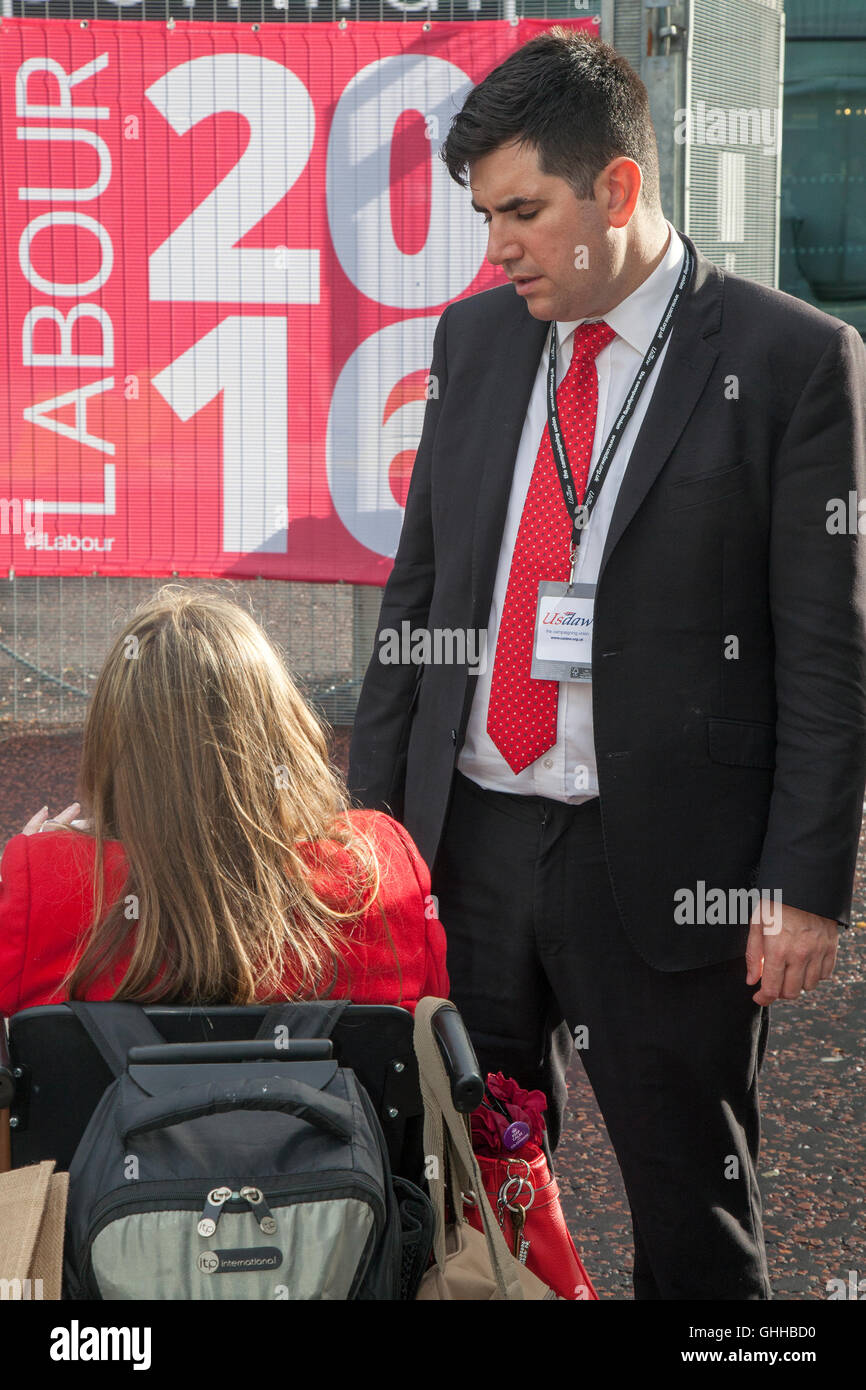 Liverpool, UK . 28th September, 2016. Liverpool, UK. 28th September, 2016. Stephen Twigg MP talking to Disabled Jacqueline Robinson who cuts a lonley figure outside the entrance to the Labour Party conference in Liverpool.  Jacqueline, (Mum, Meningitis survivor, Union activist), a paid up member of the Labour Party has been suspended & banned from attending the conference.  She is a member of the Unite & Communications Workers Union and an activist for DPAC, 'Disabled People Against Cuts' and a lifelong Labour supporter. Credit:  Cernan Elias/Alamy Live News Stock Photo