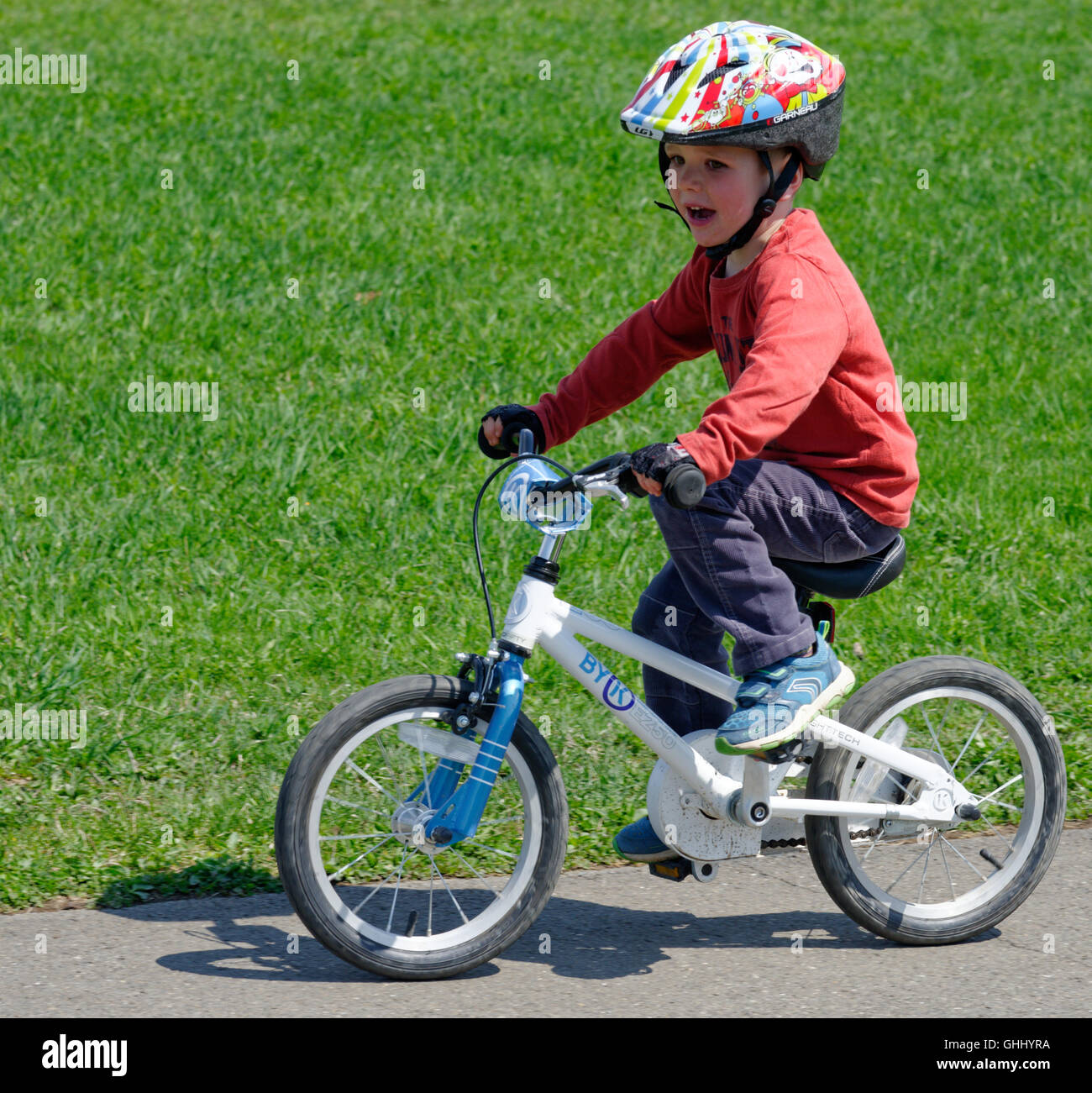 A four year old boy riding his bike Stock Photo Alamy