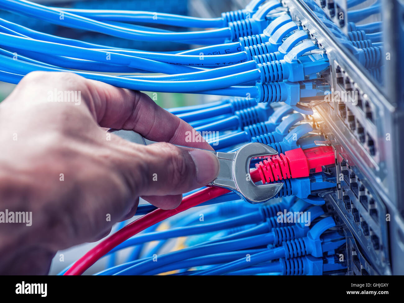 man Repair network cable to switch with wrench Stock Photo Alamy