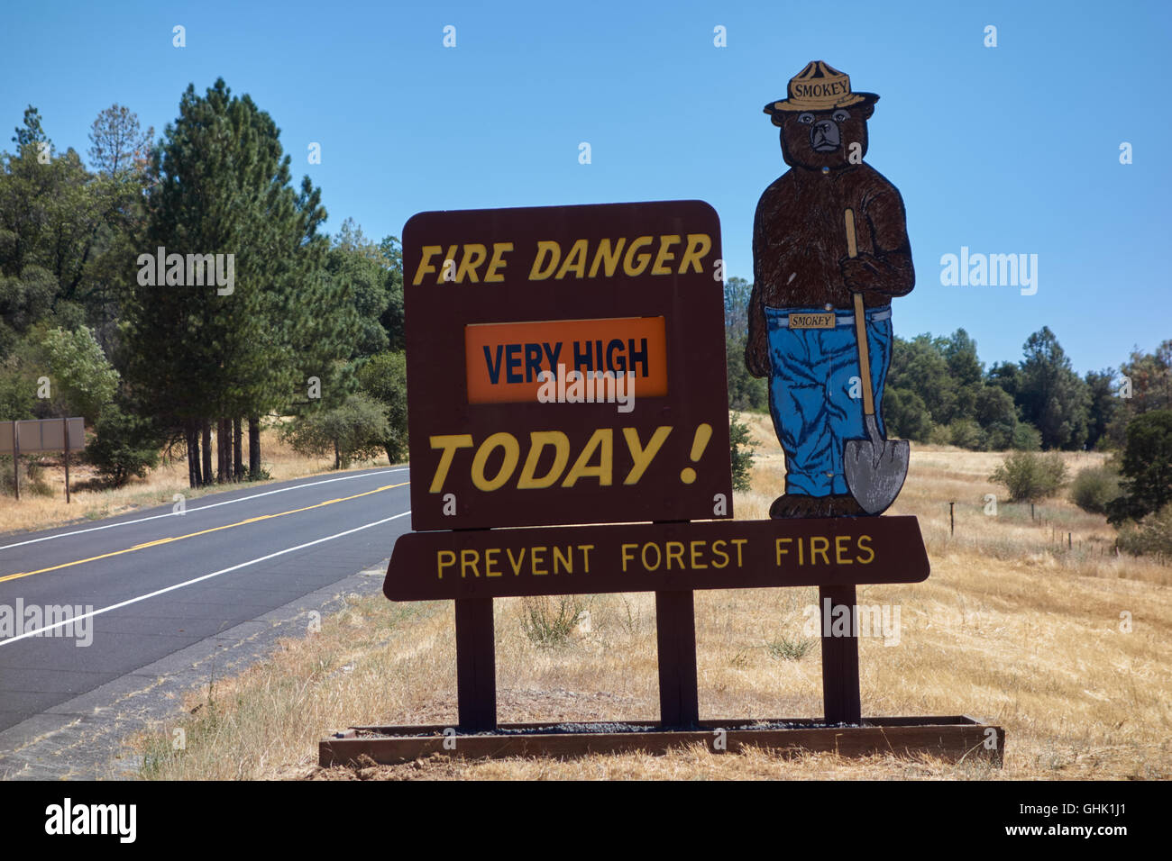 Very high risk of fire warning sign on side of road with figure of Yogi bear. Near Yosemite National Park.  California. USA Stock Photo