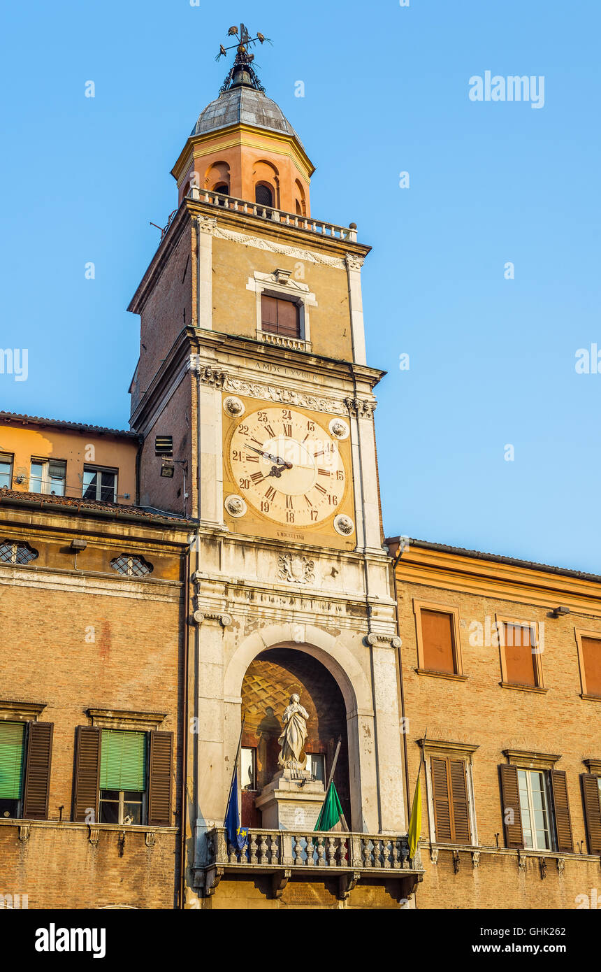 Torre delle Orologio, Clock tower, of Palazzo Comunale, city hall, in Piazza Grande of Modena at sunset. Emilia-Romagna. Italy. Stock Photo