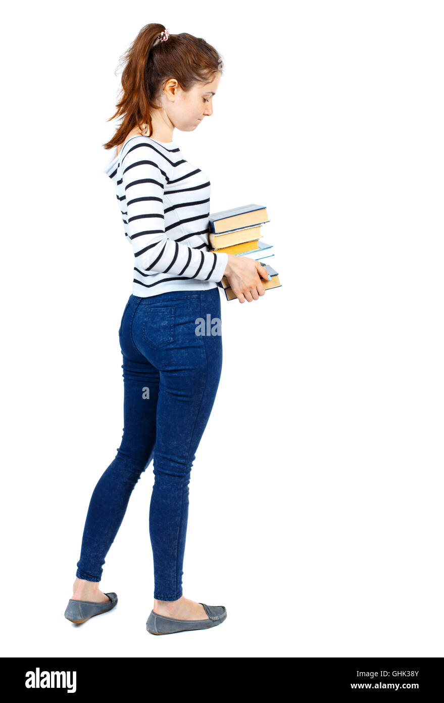 Girl carries a heavy pile of books. back view Stock Photo - Alamy