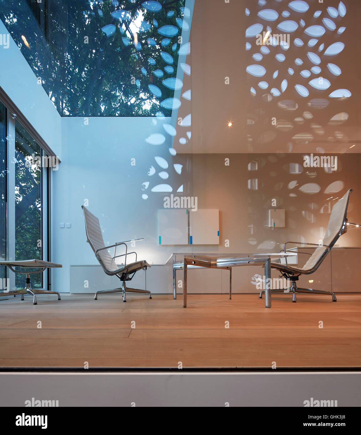 Detail of living area with glass reflection. House in Brixton, London