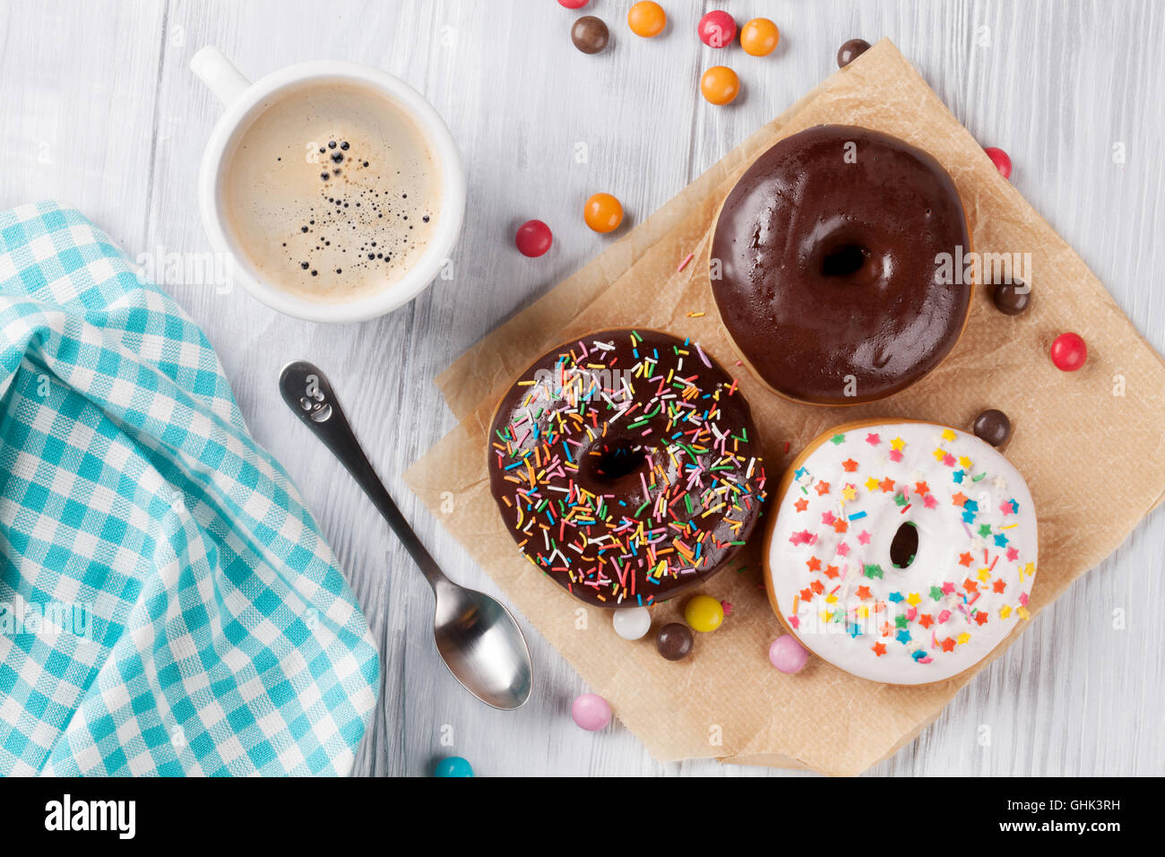 Donuts and coffee on wooden table. Top view Stock Photo - Alamy