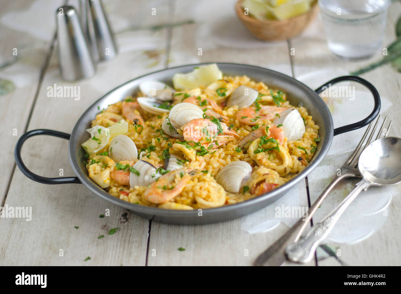 Spanish paella with prawns, squid and clams Stock Photo