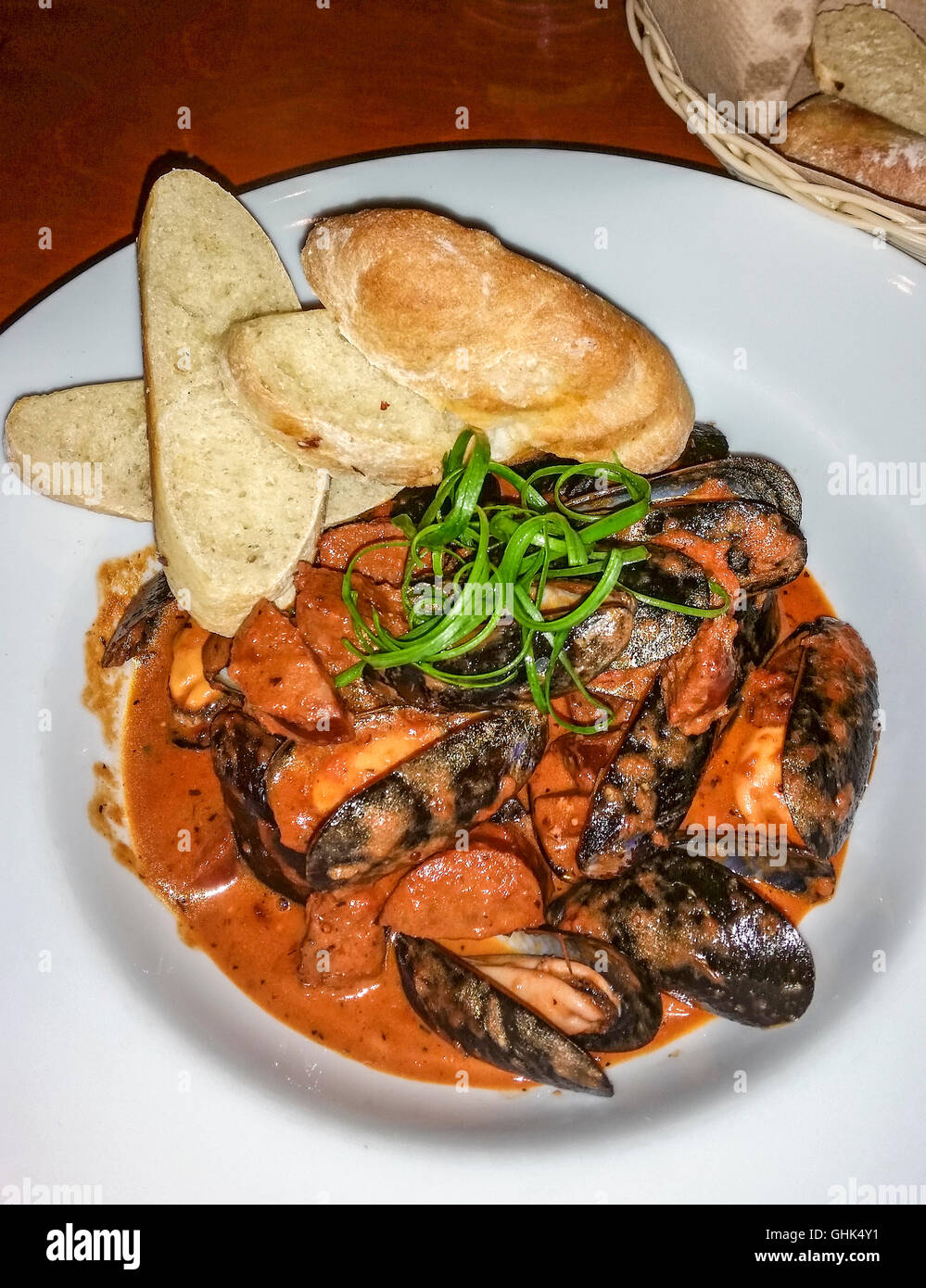 Steamed P.E.I mussels in smoky roasted tomato cream sauce Stock Photo