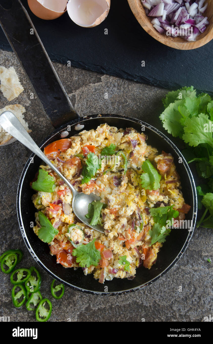 Indian scrambled eggs with tomatoes and chillies Stock Photo