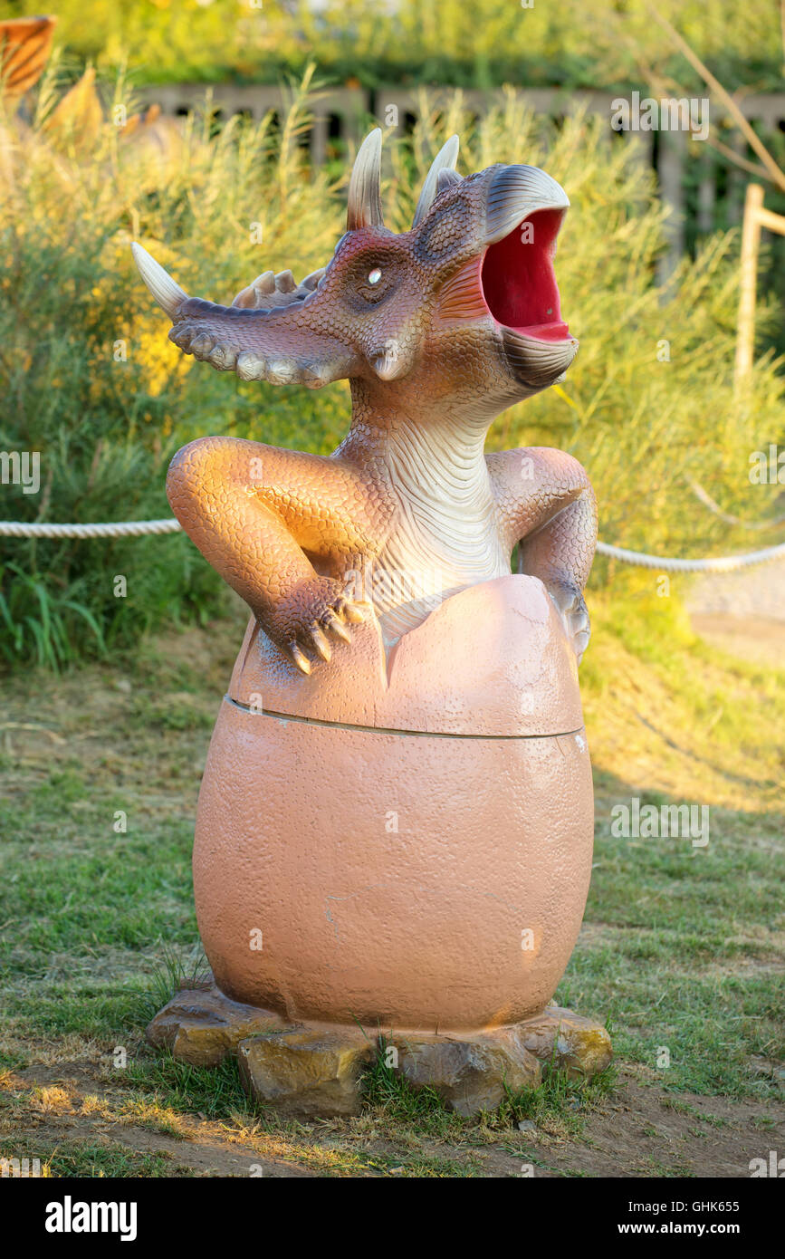 NOVI SAD, SERBIA - AUGUST 5, 2016: Small dinosaur trash bin toy from themed entertainment Dino Park in Novi Sad. Stock Photo