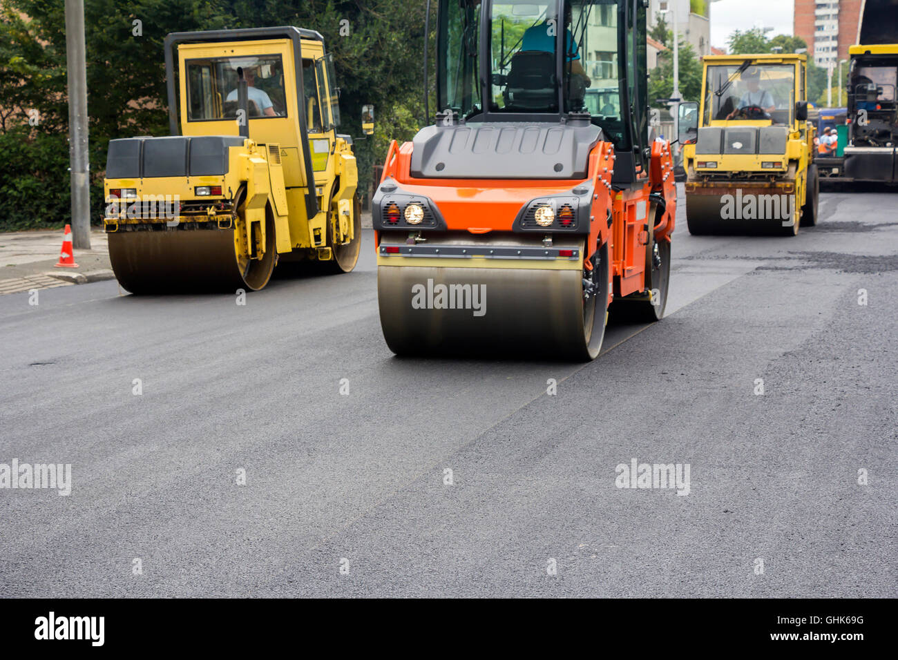 Compactor roller during road construction at asphalting work Stock Photo