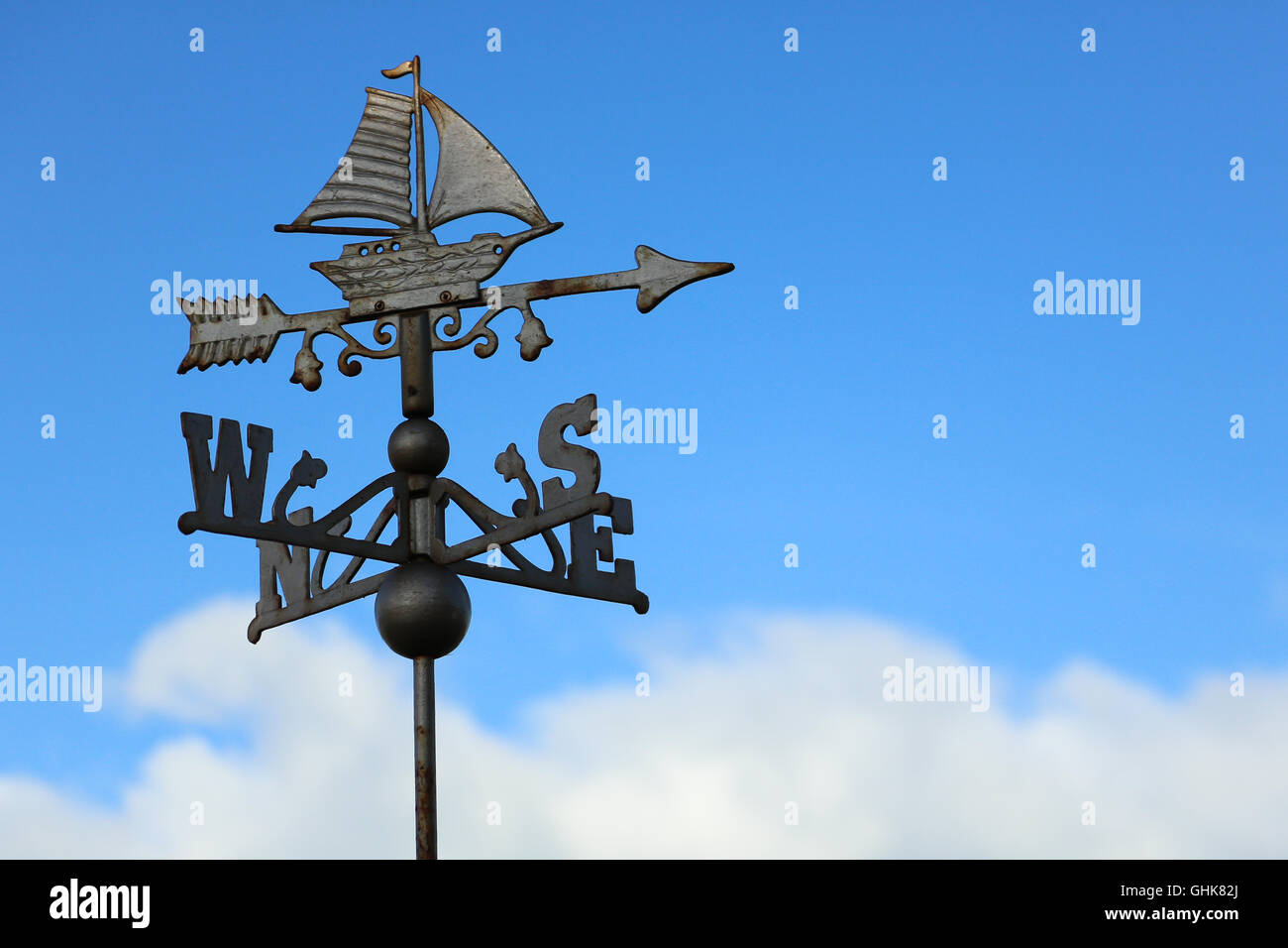 Weather vane with sailboat and all four wind directions Stock Photo Alamy