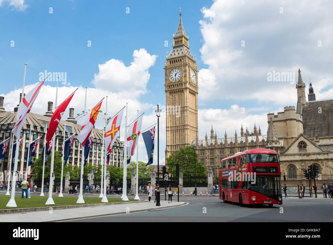 London Scene with red Double Decker Bus and the Big Ben Clock Tower and Westminster abbey Stock Photo