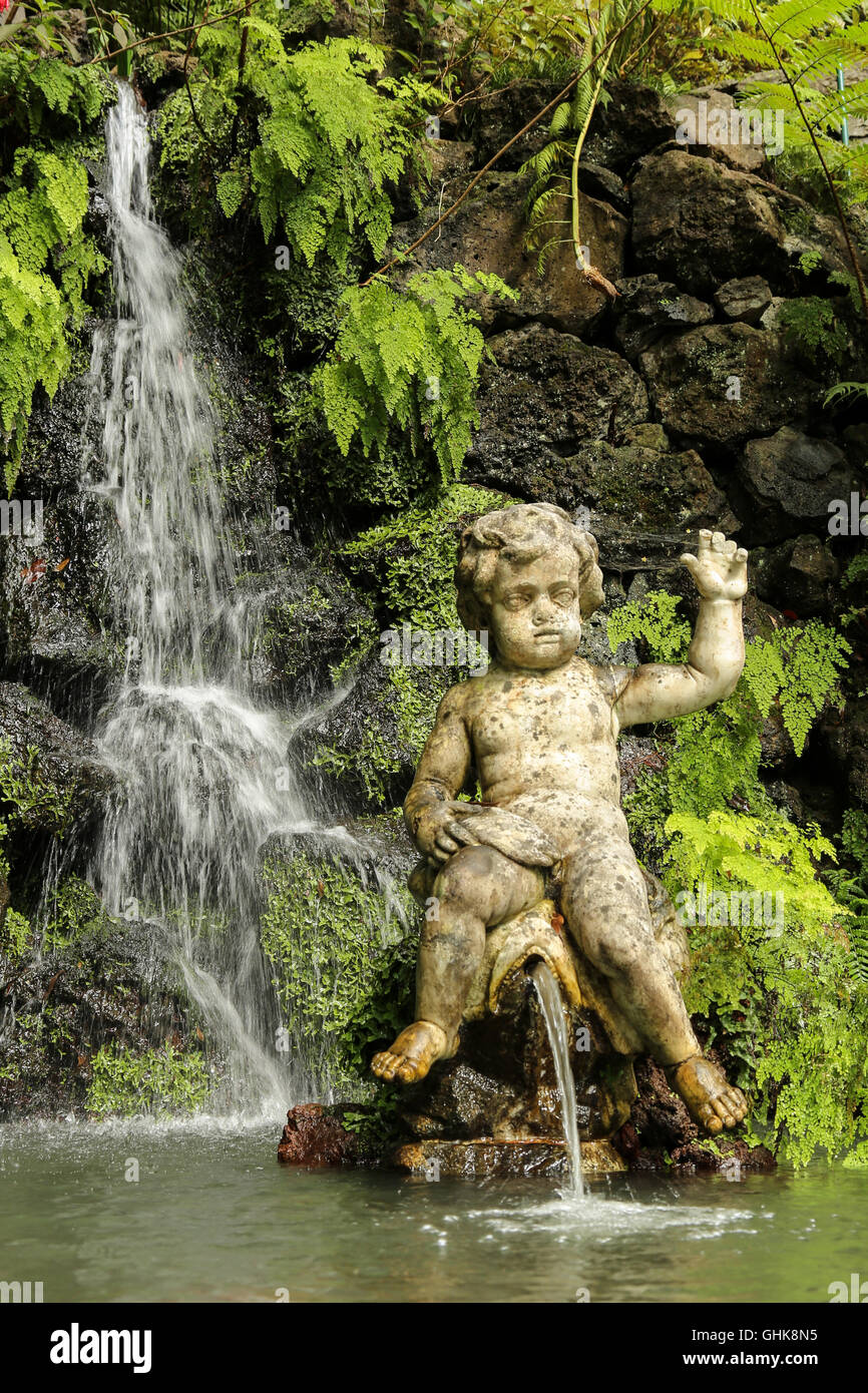 fountain Statue and waterfall in tropical garden in Funchal, Madaira