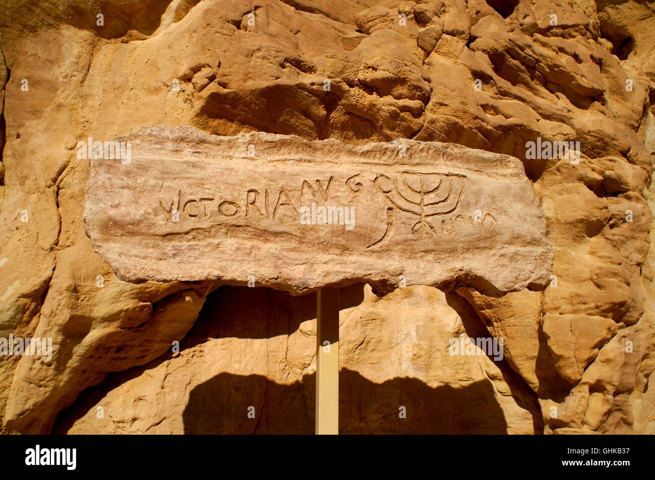 Prehistoric Rock art in the desert depicting a Jewish Menorah near a ...