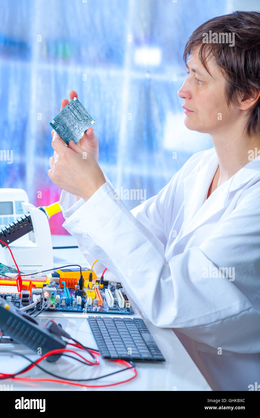 Woman repair electronics device Stock Photo Alamy
