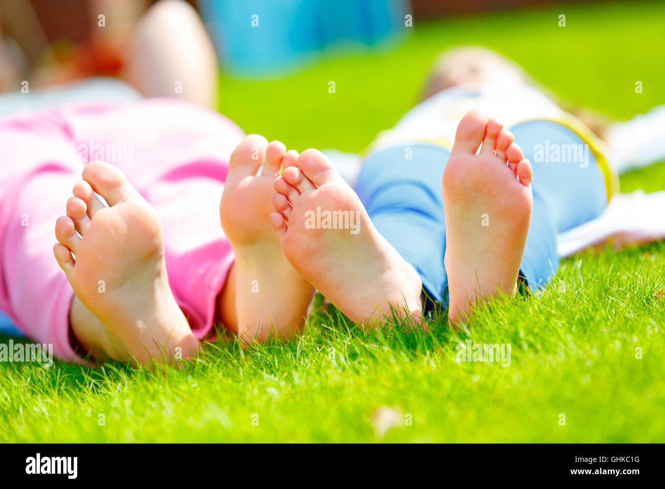 Girl foot on green grass Stock Photo