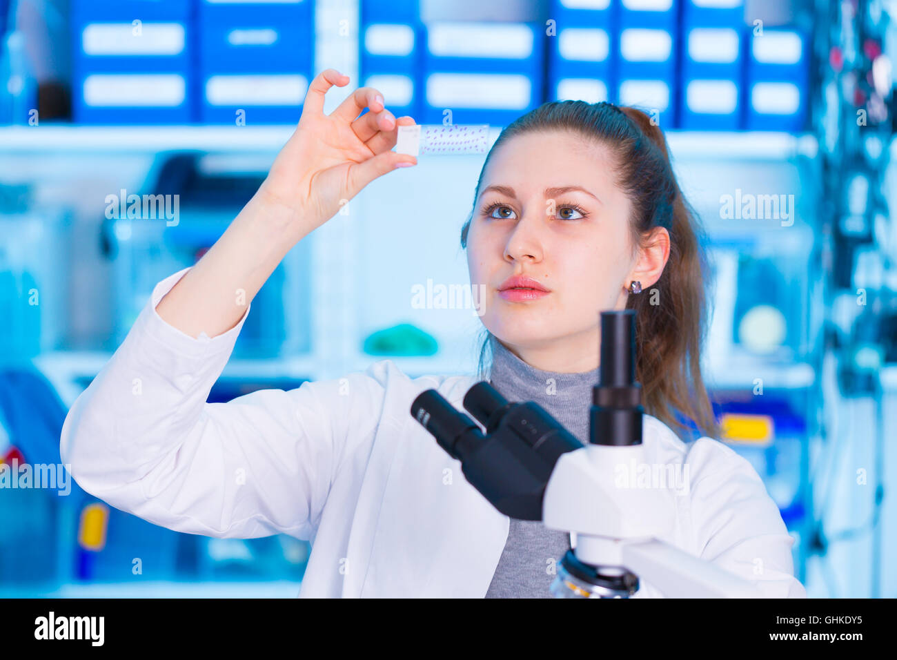 woman technician with microscope slide in lab Stock Photo - Alamy