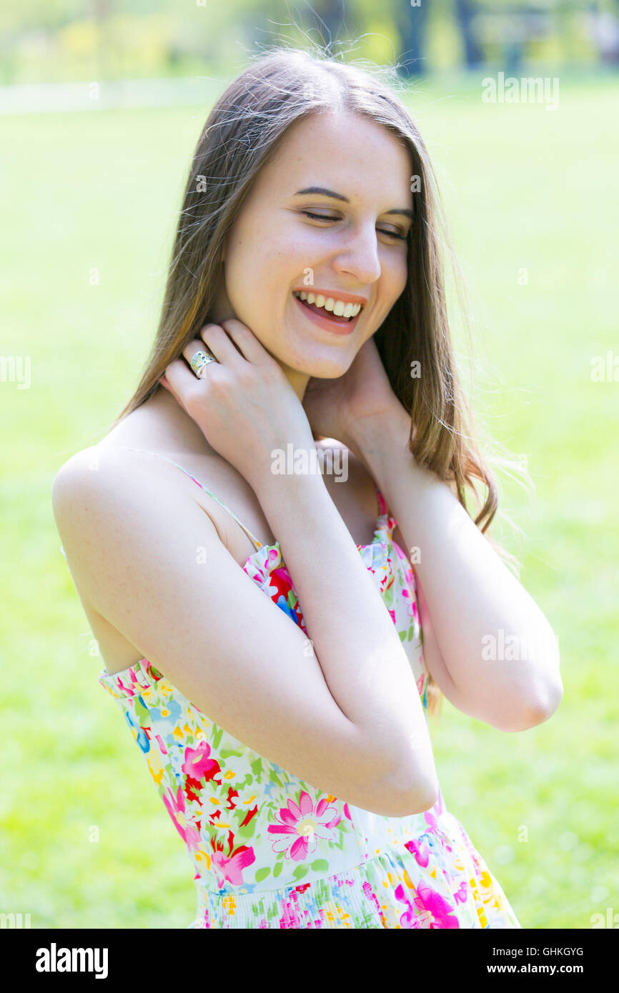 Young pretty woman with long hair in park Stock Photo
