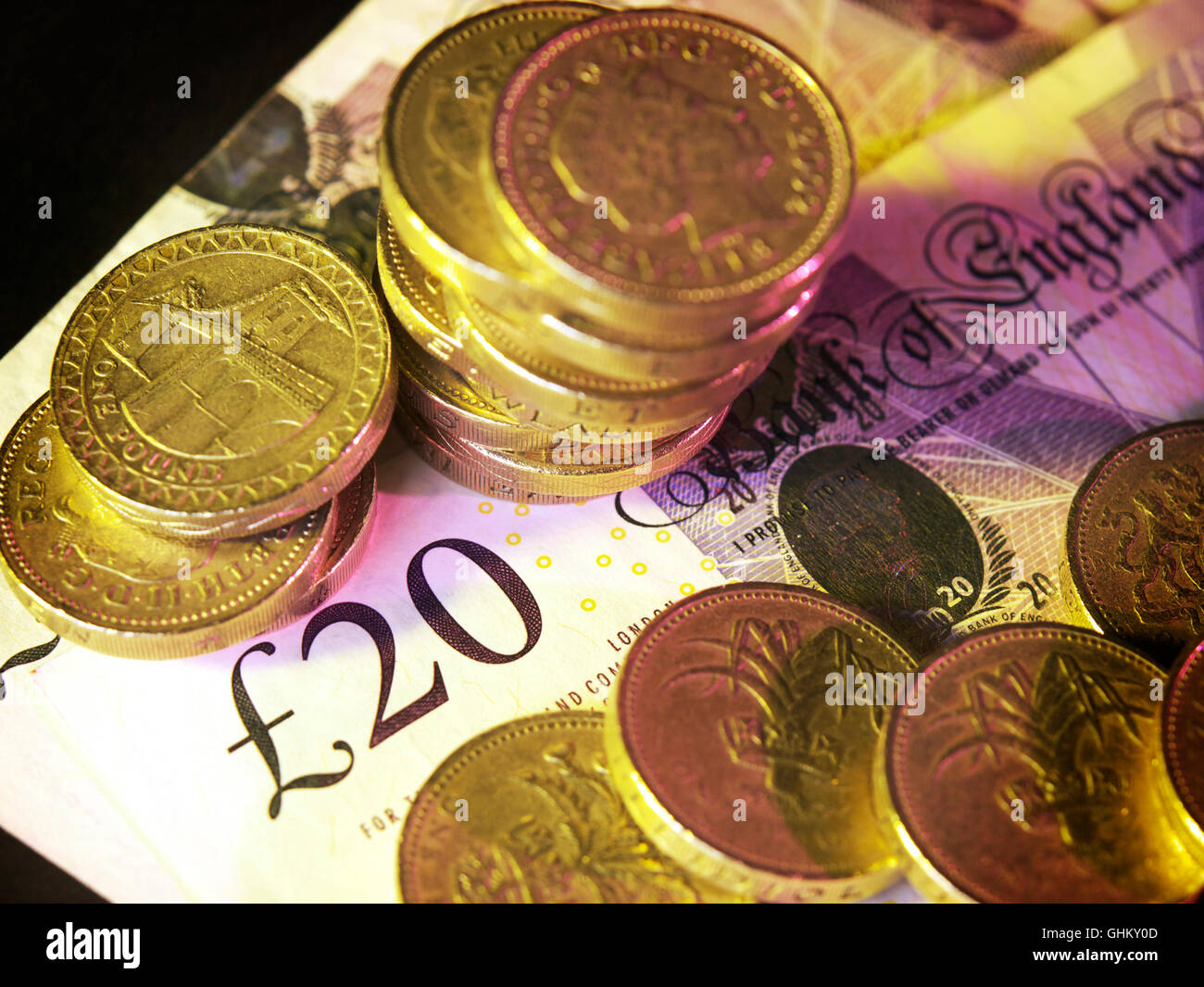 UK currency, pound coins laying on a twenty pound note Stock Photo