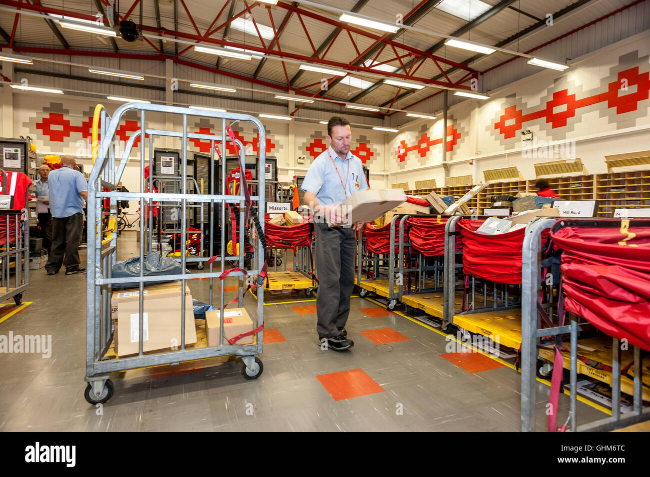 Postal workers sorting the mail in a sorting office in southern England Stock Photo Alamy