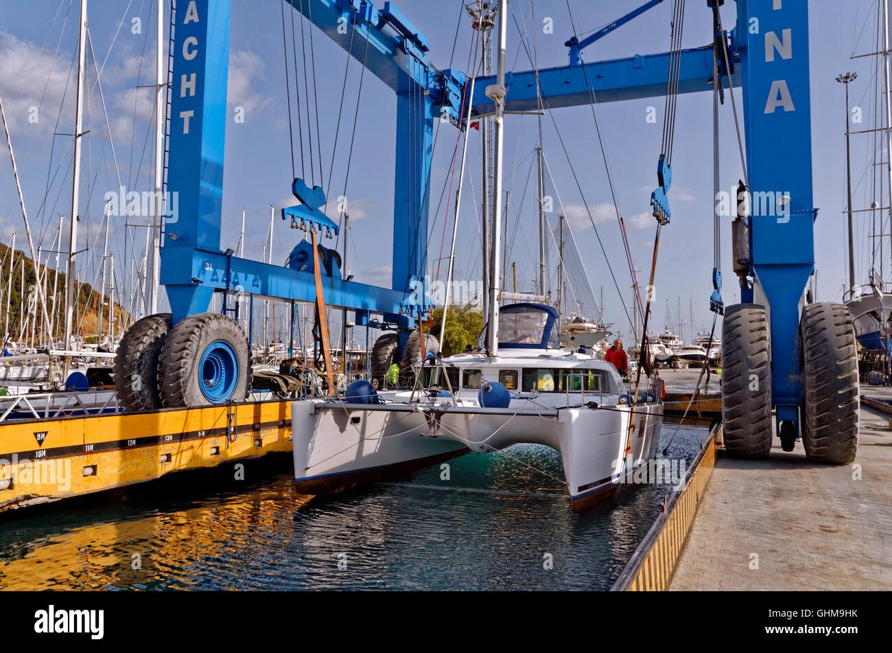 Catamaran being lifted or launched by yacht crane. Stock Photo