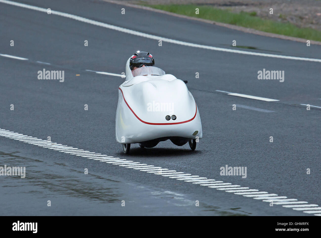 Velomobile, A man on a bike ride in an unusual vehicle. Stock Photo