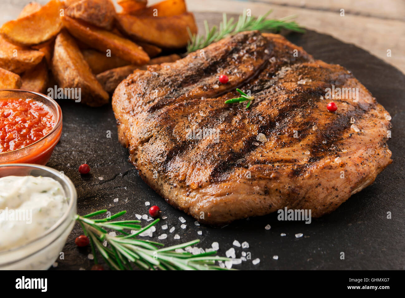 Beef steak with baked potato and sauce Stock Photo - Alamy