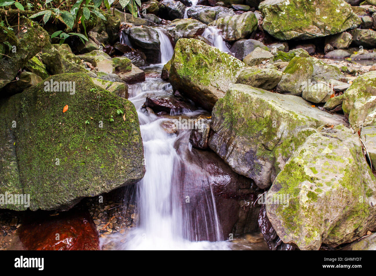 Water stream moving through rocks Stock Photo - Alamy