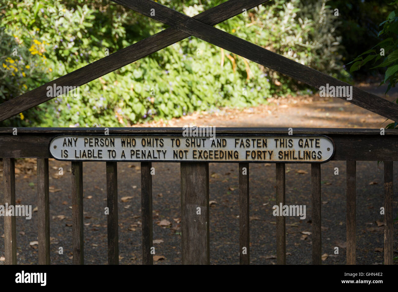 Gate at Lelant in Cornwall with interesting sign for walkers- shut the gate or face a penalty Stock Photo