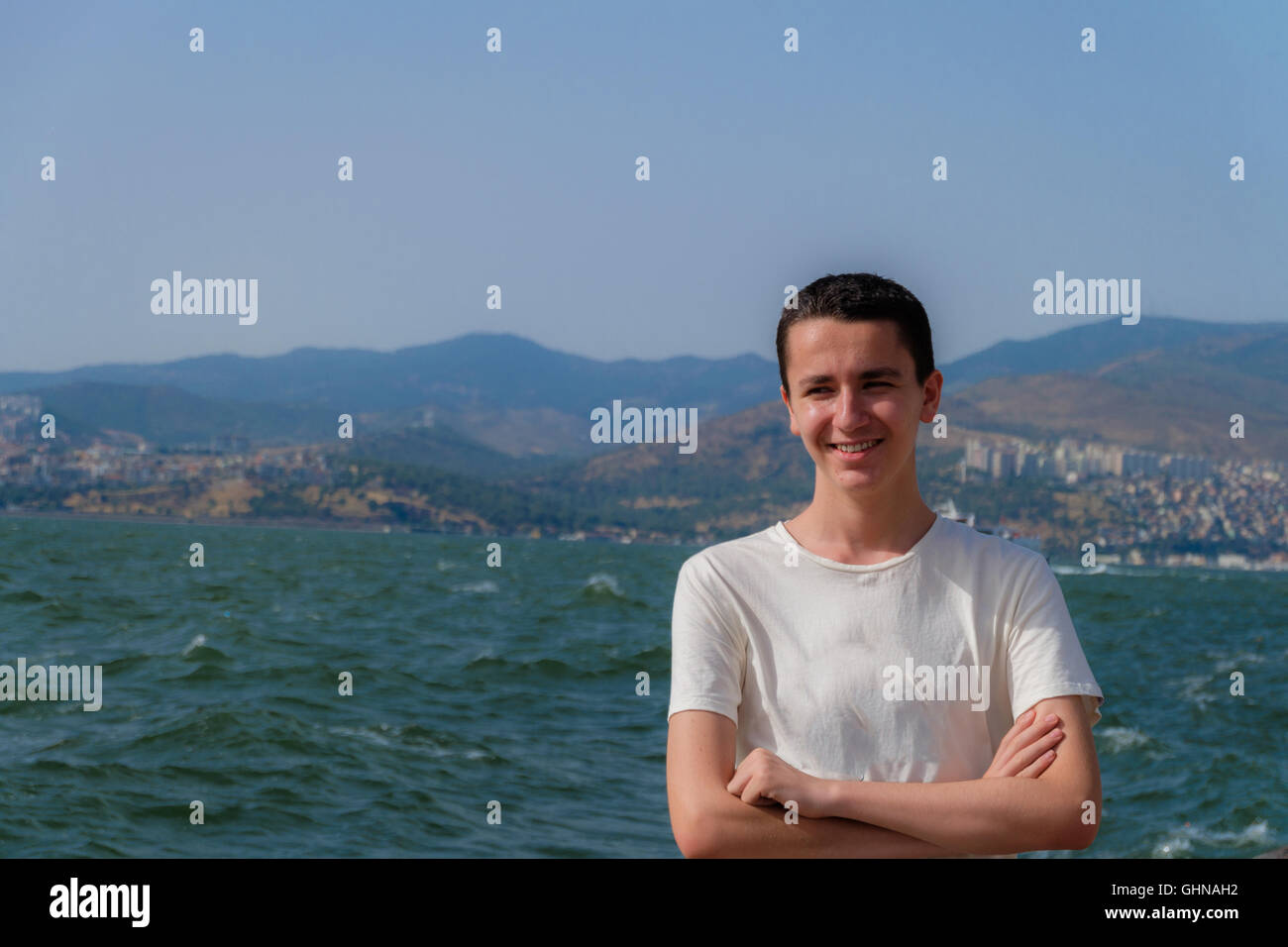 Portrait of a young  handsome boy smilling in front of city Stock Photo
