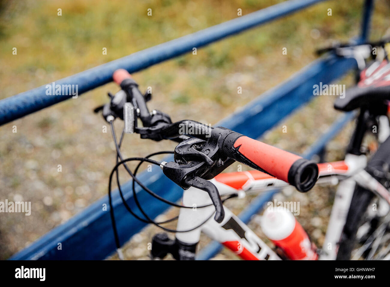 closeup mountain bike handlebar sports, rain drops on bicycle Stock Photo