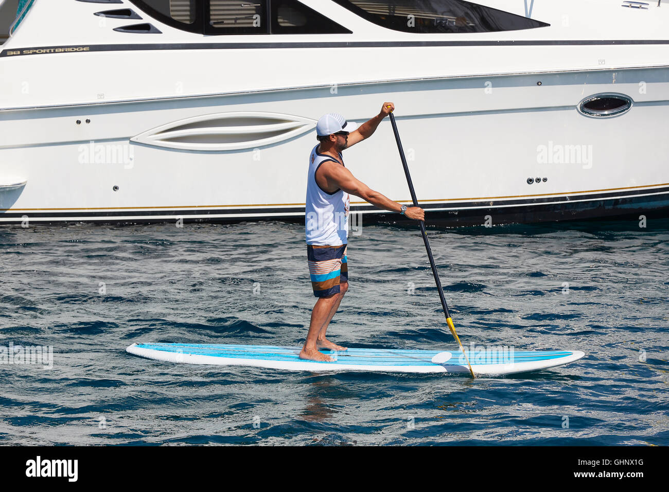 Young Man On A Paddle Board In Avalon Harbor, Catalina Island, California. Stock Photo