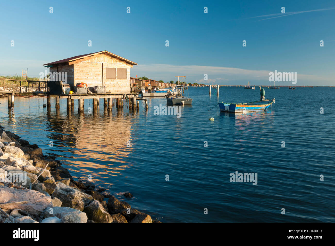 View of fishing hut and boats at the Scardovari Lagoon, Po river estuary, Rovigo, Italy Stock Photo